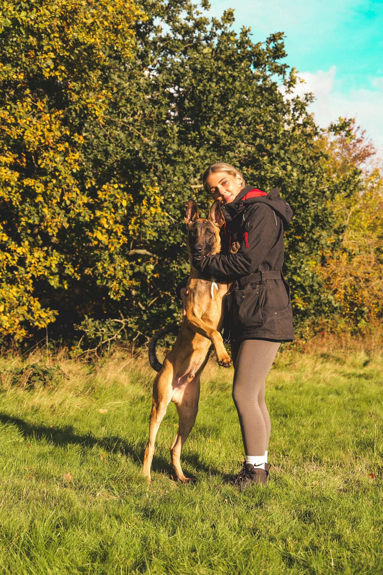 Holly hugging a Malinois